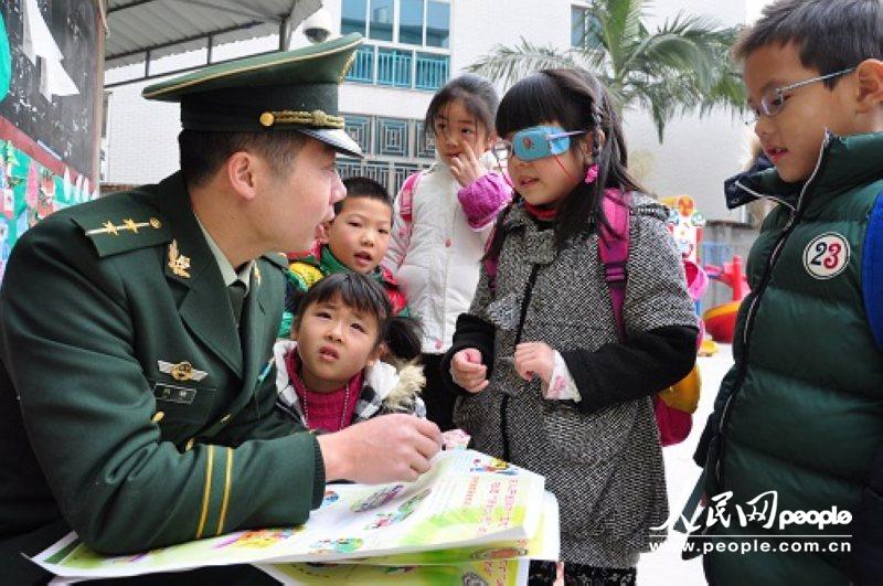 边防官兵给小朋友讲解安全常识。（李剑虬 摄）
